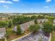 Aerial view of colorful townhomes with mature trees and parking spaces at 4429 Sw 49Th Ave, Ocala, FL 34474