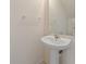 Cozy half bathroom with a pedestal sink, mirror, and neutral wall color at 4429 Sw 49Th Ave, Ocala, FL 34474