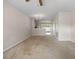 Bright living room flowing into the kitchen, with carpet and a ceiling fan at 4429 Sw 49Th Ave, Ocala, FL 34474