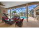 Comfortable outdoor seating on a covered patio with views of the screened pool and backyard at 4731 Se 34Th St, Ocala, FL 34480
