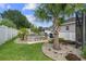 A landscaped backyard features tropical palms and a serene water feature at 4731 Se 34Th St, Ocala, FL 34480