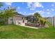 Private backyard featuring a stone-accented spa, lush lawn and partial fencing at 4731 Se 34Th St, Ocala, FL 34480