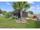 Relaxing backyard with a screened pool, palm trees, and a cozy fire pit area at 4731 Se 34Th St, Ocala, FL 34480