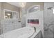 Luxurious bathroom featuring soaking tub, fireplace, walk-in shower, and dual sinks at 4731 Se 34Th St, Ocala, FL 34480