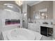 Beautiful bathroom featuring soaking tub, fireplace, walk-in shower, and dual sinks with mini-fridge at 4731 Se 34Th St, Ocala, FL 34480
