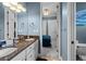 Bathroom showcasing double sinks with granite counters, decorative lighting, and open view to the bedroom at 4731 Se 34Th St, Ocala, FL 34480