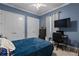 Cozy blue bedroom with a large bed, desk, and ample storage provided by the built-in closet doors at 4731 Se 34Th St, Ocala, FL 34480
