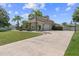 Spacious driveway leading to a well-maintained home with a three-car garage and lush landscaping at 4731 Se 34Th St, Ocala, FL 34480