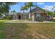 Charming single-story home featuring stone accents, a well-manicured lawn, and tropical palm trees at 4731 Se 34Th St, Ocala, FL 34480