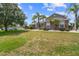 Well-kept front yard showcasing the side of a charming home with stone accents and mature trees at 4731 Se 34Th St, Ocala, FL 34480