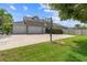 Large three-car garage with basketball hoop, lush lawn and mature trees at 4731 Se 34Th St, Ocala, FL 34480