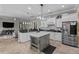 Open concept kitchen with island, stainless steel refrigerator, and seamless flow to the living area at 4731 Se 34Th St, Ocala, FL 34480