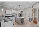 Bright kitchen with white cabinetry, a gray island, stainless steel appliances, and stone tile flooring at 4731 Se 34Th St, Ocala, FL 34480