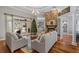 Spacious living room with a stone fireplace, hardwood floors, and backyard views at 4731 Se 34Th St, Ocala, FL 34480