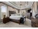 Spacious main bedroom with a large bed, decorative tray ceiling, and warm, inviting decor at 4731 Se 34Th St, Ocala, FL 34480