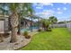 A spacious backyard with a screened-in pool and surrounding tropical landscaping at 4731 Se 34Th St, Ocala, FL 34480