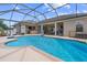 This backyard boasts a sparkling pool and an outdoor kitchen under the screened enclosure at 4731 Se 34Th St, Ocala, FL 34480