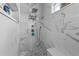 Modern walk-in shower with elegant marble tile, rainfall shower head, and built-in bench at 4731 Se 34Th St, Ocala, FL 34480