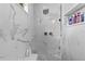 Stylish marble shower with glass door, rainfall shower head, and built-in shelving at 4731 Se 34Th St, Ocala, FL 34480