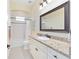Classic bathroom featuring a bathtub/shower combo, granite countertop and vanity with framed mirror at 5024 Sw 114Th Street Rd, Ocala, FL 34476
