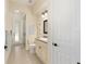 Well-lit bathroom with granite countertops, a toilet, walk-in shower and a view of the backyard at 5024 Sw 114Th Street Rd, Ocala, FL 34476