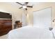 Spacious bedroom featuring a ceiling fan and light fixture, dresser, and closet space at 5024 Sw 114Th Street Rd, Ocala, FL 34476