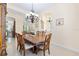 Spacious dining room with ornate wood table and view to living room and kitchen at 5024 Sw 114Th Street Rd, Ocala, FL 34476