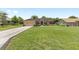 Beautiful single-story home with a long driveway and a lush green lawn at 5024 Sw 114Th Street Rd, Ocala, FL 34476