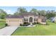 Charming single-story home with a well-manicured lawn and a classic stucco facade at 5024 Sw 114Th Street Rd, Ocala, FL 34476