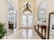 Spacious foyer with tile floors, high ceilings and a view of the study and front doors at 5024 Sw 114Th Street Rd, Ocala, FL 34476