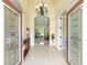 Welcoming foyer featuring a chandelier, tile flooring, and open view to the living room at 5024 Sw 114Th Street Rd, Ocala, FL 34476