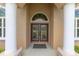 Close up of front entrance with large white columns and decorative glass paneled double door at 5024 Sw 114Th Street Rd, Ocala, FL 34476