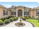 Inviting front entrance with elegant double doors and decorative landscaping at 5024 Sw 114Th Street Rd, Ocala, FL 34476
