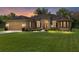 Beautiful home exterior featuring a well-maintained lawn, manicured landscaping, and an attached two-car garage at 5024 Sw 114Th Street Rd, Ocala, FL 34476