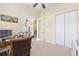 Home office featuring a wooden desk, file cabinets, and French doors that lead to the living room at 5024 Sw 114Th Street Rd, Ocala, FL 34476