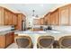 Kitchen featuring a bar-height counter with granite countertop and wood cabinetry at 5024 Sw 114Th Street Rd, Ocala, FL 34476