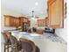 Kitchen featuring bar seating, granite counters, stainless steel appliances, and wood cabinetry at 5024 Sw 114Th Street Rd, Ocala, FL 34476