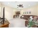 Inviting living room open to the dining area with a large sectional couch, ceiling fan, and neutral colors at 5024 Sw 114Th Street Rd, Ocala, FL 34476