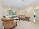 Bright living room featuring carpet flooring, neutral walls and large sliding glass doors at 5024 Sw 114Th Street Rd, Ocala, FL 34476