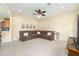 Spacious living room with a large sectional couch, carpet floors, and a ceiling fan at 5024 Sw 114Th Street Rd, Ocala, FL 34476
