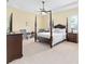 Main bedroom featuring a four-poster bed, sitting area, and bright windows at 5024 Sw 114Th Street Rd, Ocala, FL 34476