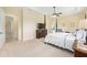 Spacious main bedroom featuring a four-poster bed, sitting area, and lots of natural light at 5024 Sw 114Th Street Rd, Ocala, FL 34476