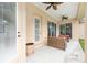 Cozy outdoor patio with ceiling fans, comfortable seating, and serene backyard views at 5024 Sw 114Th Street Rd, Ocala, FL 34476