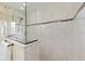 Close-up of the walk-in shower, highlighting the elegant tilework, and frameless glass enclosure at 5024 Sw 114Th Street Rd, Ocala, FL 34476