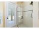 Shower with clear glass doors, tiled walls, and views of the outside patio at 5024 Sw 114Th Street Rd, Ocala, FL 34476