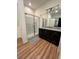 Well-lit bathroom with granite vanity, glass-enclosed shower, and modern fixtures at 5235 Nw 33Rd Pl, Ocala, FL 34482