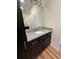Modern bathroom with granite countertop and dark wood vanity at 5235 Nw 33Rd Pl, Ocala, FL 34482