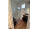 Bright bathroom featuring a shower, granite vanity, and wood-look floors at 5235 Nw 33Rd Pl, Ocala, FL 34482