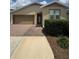 Inviting home with a brick-paved walkway leading to the front entrance and lush green landscaping at 5235 Nw 33Rd Pl, Ocala, FL 34482