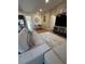 Open-concept living room featuring a large sectional sofa and adjacent dining area at 5235 Nw 33Rd Pl, Ocala, FL 34482